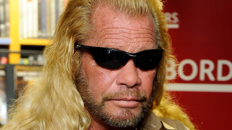 Dog the Bounty Hunter poses at an event