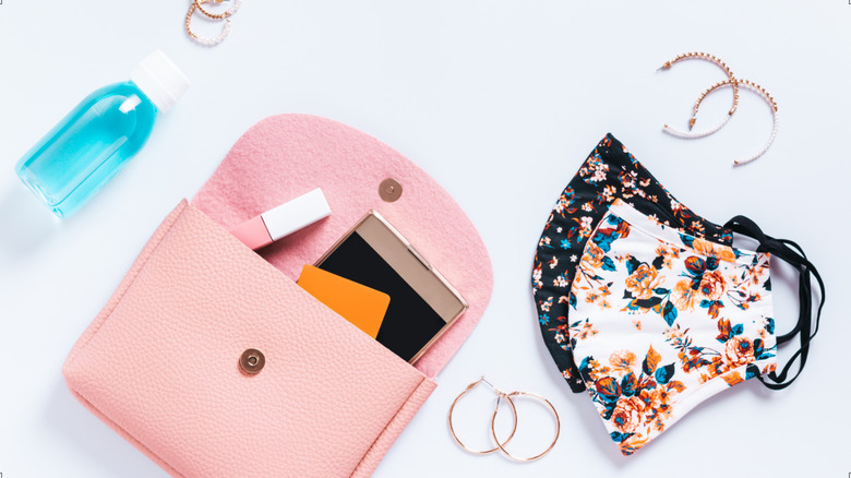pink purse, phone, masks, earrings