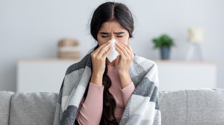 Woman sneezing