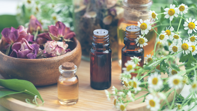 brown glass oil bottles and flowers