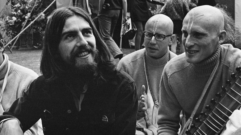 George Harrison sits with members of the Hare Krishna movement, 28th August 1969.
