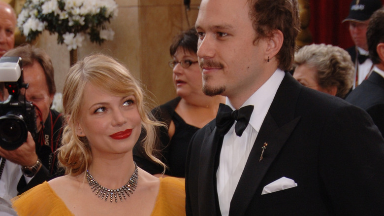 Michelle Williams with long hair looking at Heath Ledger