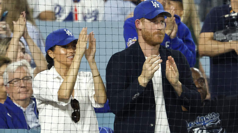 rince Harry, Duke of Sussex and Meghan, Duchess of Sussex react during the fifth inning of game four of the 2025 World Series between the Toronto Blue Jays and the Los Angeles Dodgers at Dodger Stadium on October 28, 2025 in Los Angeles, California.