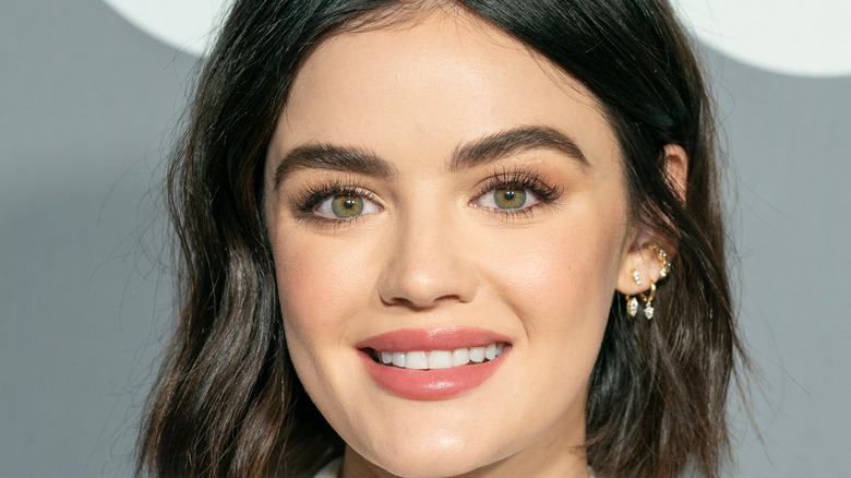 Lucy Hale smiling for press