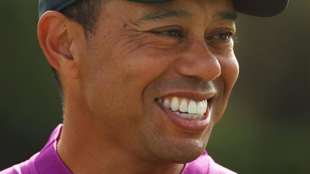 Tiger Woods smiling in purple
