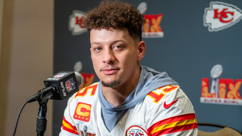 Patrick Mahomes sitting in front of microphone