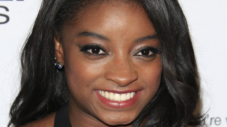 Simone Biles smiles at an event