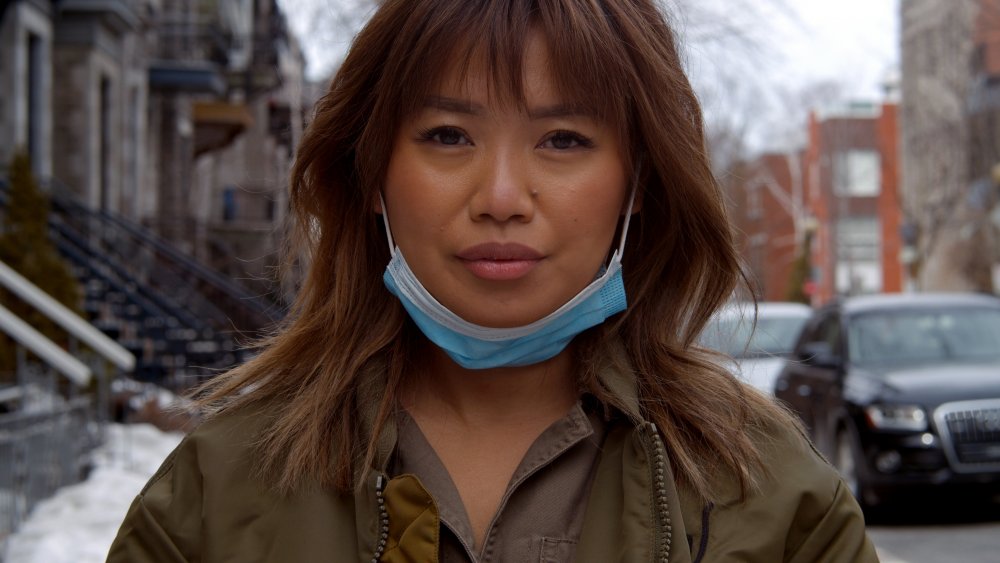 Woman wearing a face mask under the chin