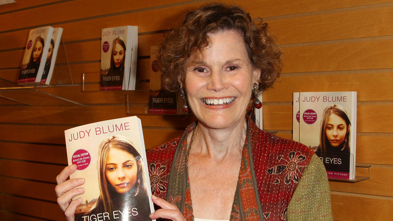 Judy Blume holding her book Tiger Eyes