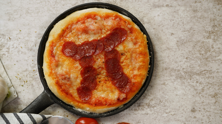 Pepperoni shaped like pi on top of a pizza
