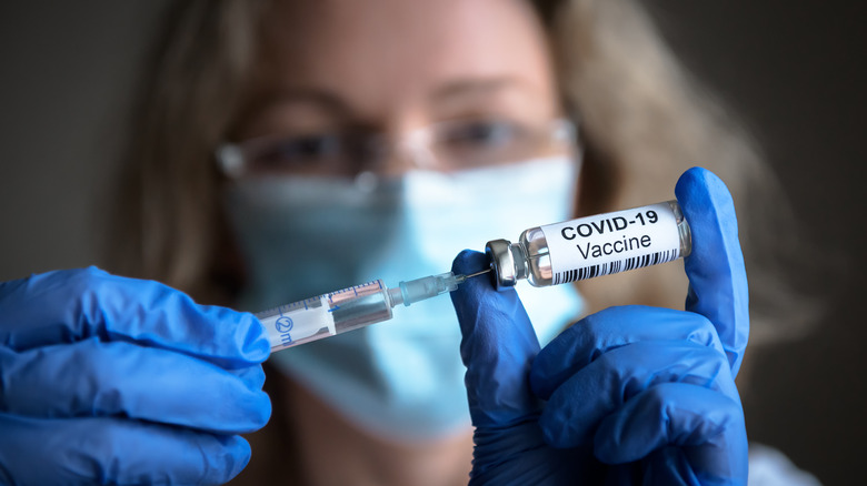 woman holding vaccine