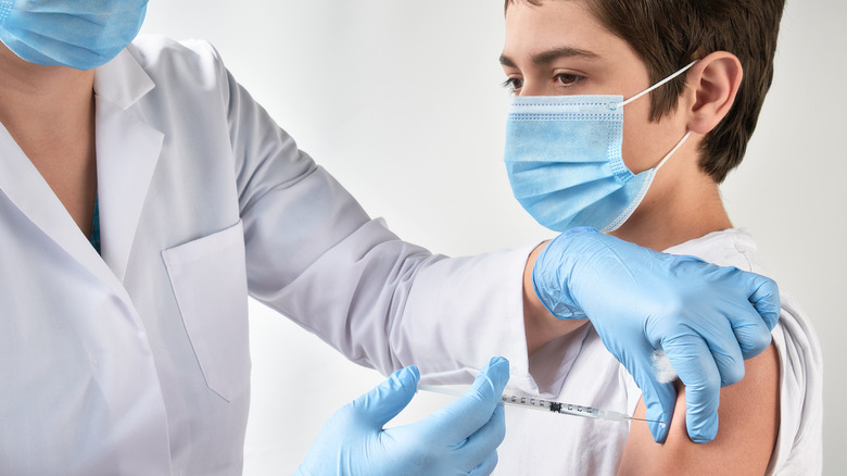 teen getting vaccinated against COVID-19