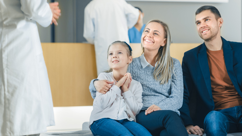 parents talking to doctor with child 