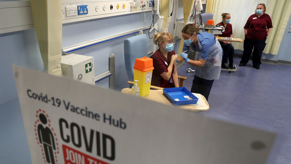 British health workers receive the COVID-19 vaccine