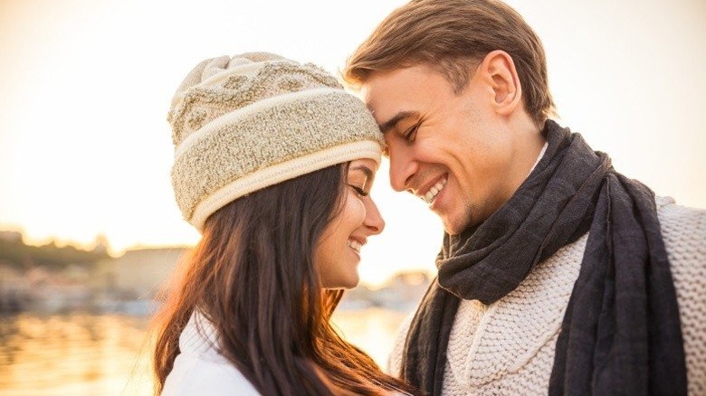 Young couple touching foreheads and smiling