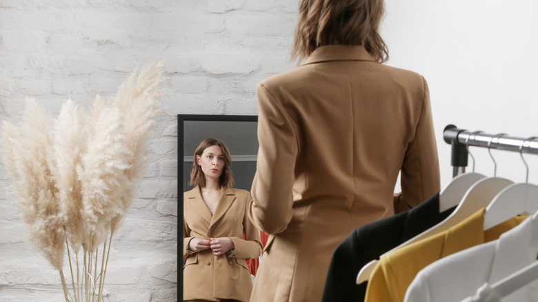 Woman wearing a cream/white fitted-waist blazer