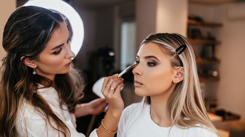 Makeup artist applying eyeshadow 