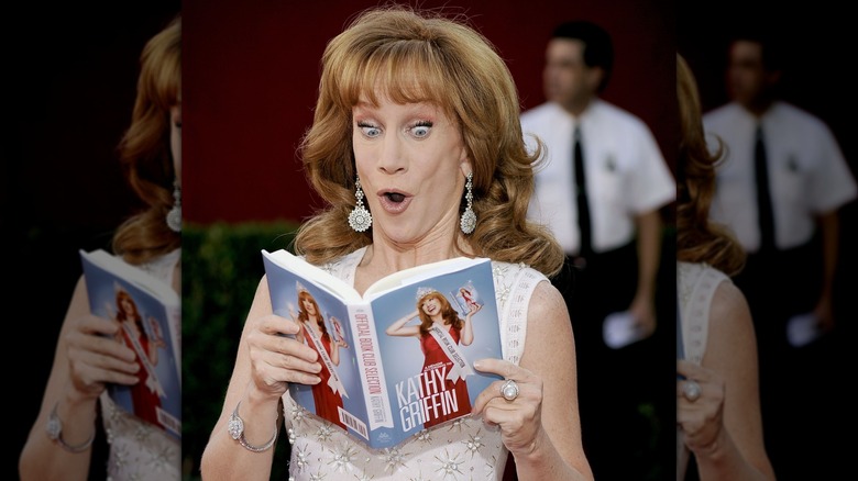 Kathy Griffin reading a copy of her book