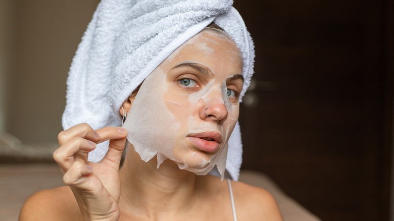 Woman towel removing face mask
