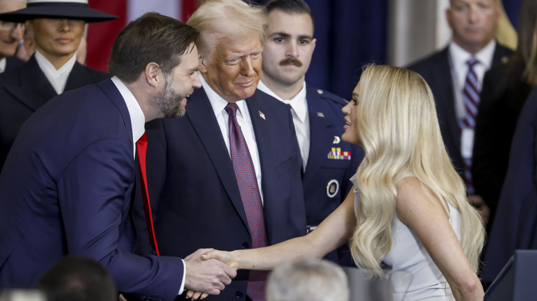 JD Vance shaking hands with Carrie Underwood with President Donald Trump