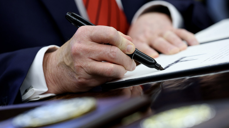 Donald Trump signs a proclamation in the Oval Office at the White House on April 17, 2025