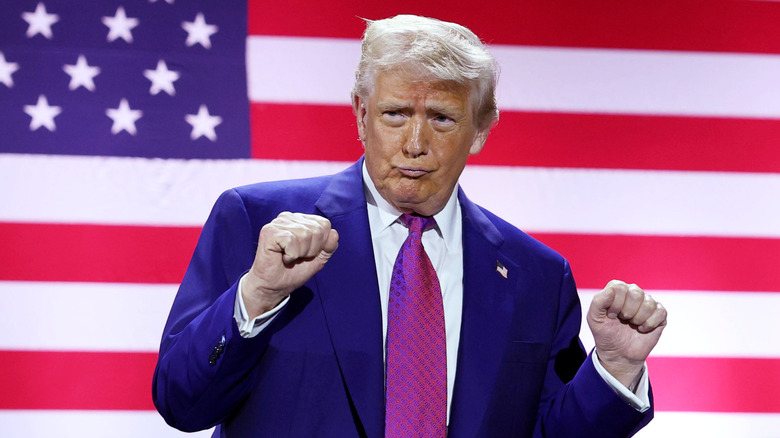 Donald J. Trump gestures on stage as he tours the Al Udeid Air Base on May 15, 2025, in Doha, Qatar