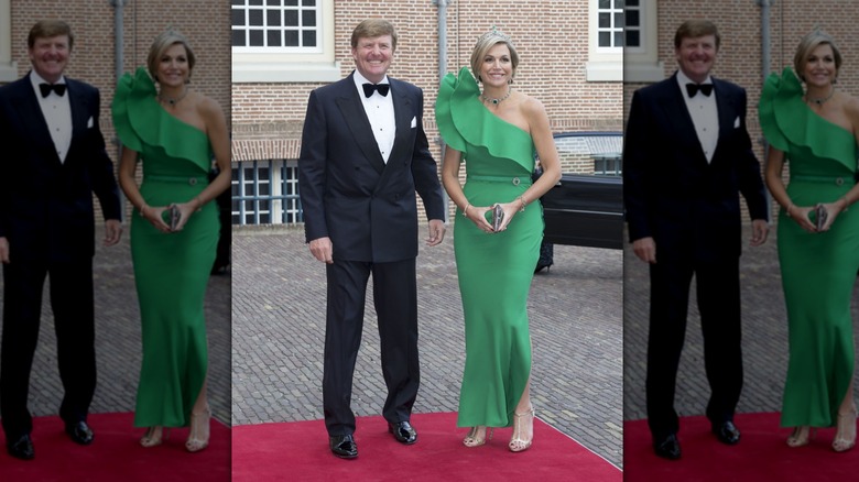 Queen Máxima smiles draped in emerald jewelry and a green dress next to King Willem-Alexander wearing a tux