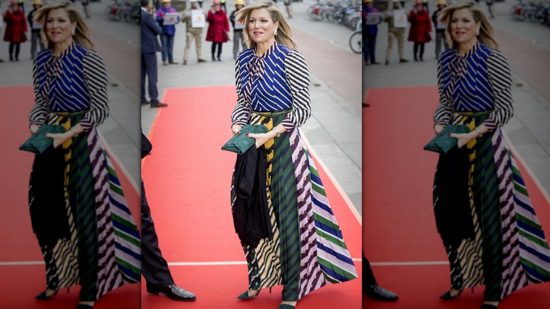 Queen Máxima arrives to a concert in a multi-colored striped suit.