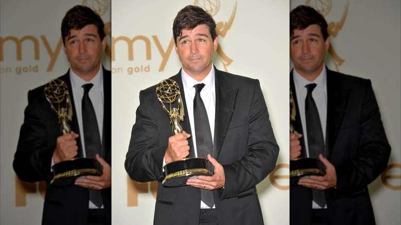 Kyle Chandler posing with an Emmy Award