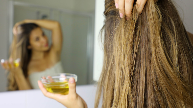Applying olive oil to hair