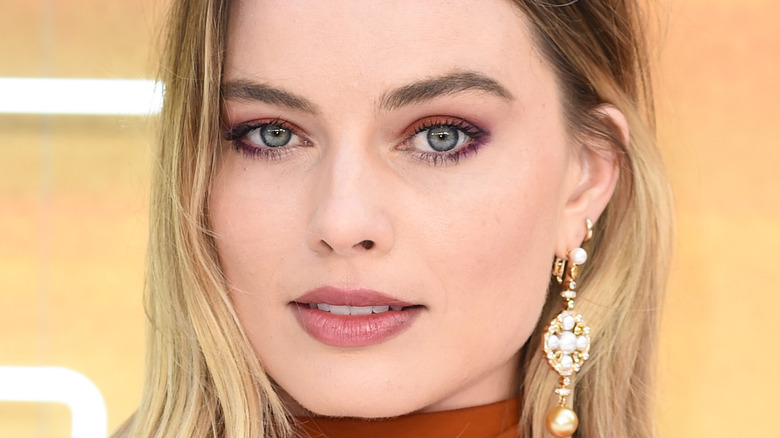 Margot Robbie poses on the red carpet