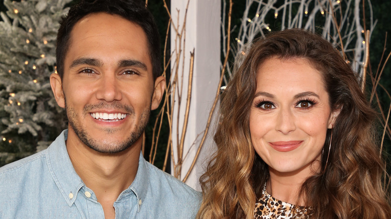 Carlos and Alexa PenaVega smiling at the camera