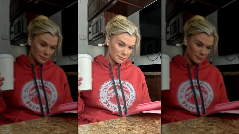 Alison Sweeney reads a script while holding coffee
