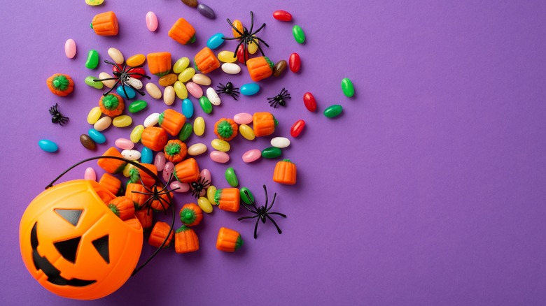 Halloween candy spilling out of a pumpkin