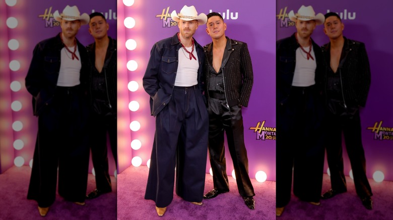 Scott Hoying posing with Mark Manio in a cowboy hat and dark denim.