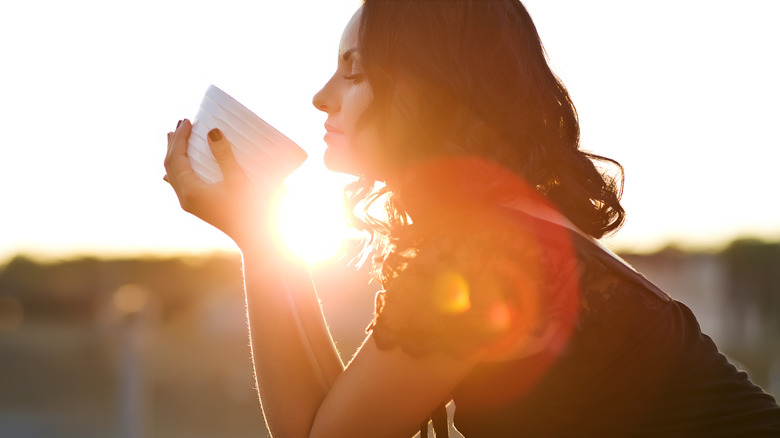 Woman drinking coffee outside