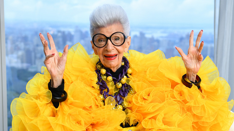 Iris Apfel gesturing in yellow