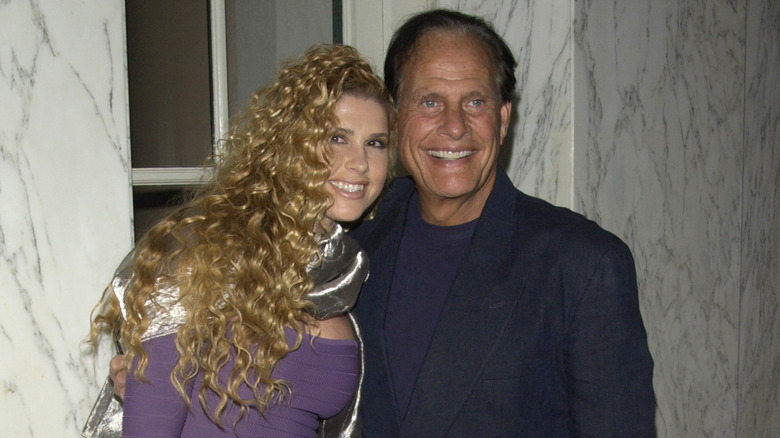 Ron Popeil smiling next to his wife, Robin
