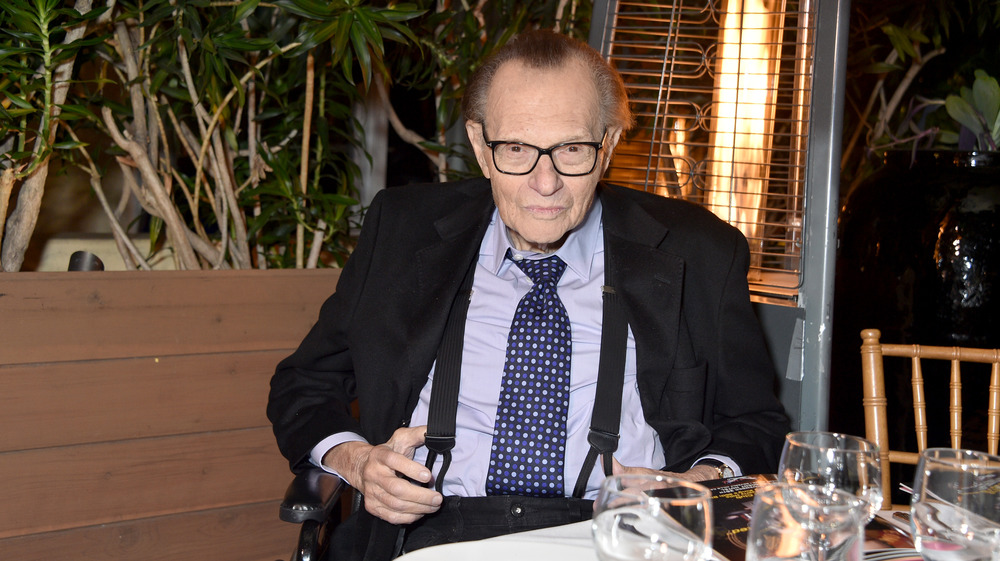Larry King attends event and smiles