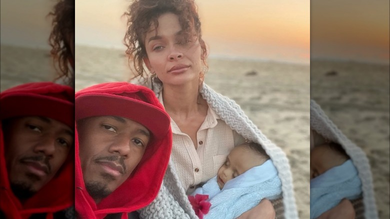 Nick Cannon, Alyssa Scott, and Zen Cannon posing 