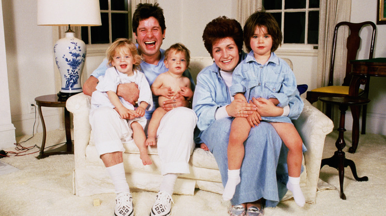 Ozzy and Sharon Osbourne smiling with children