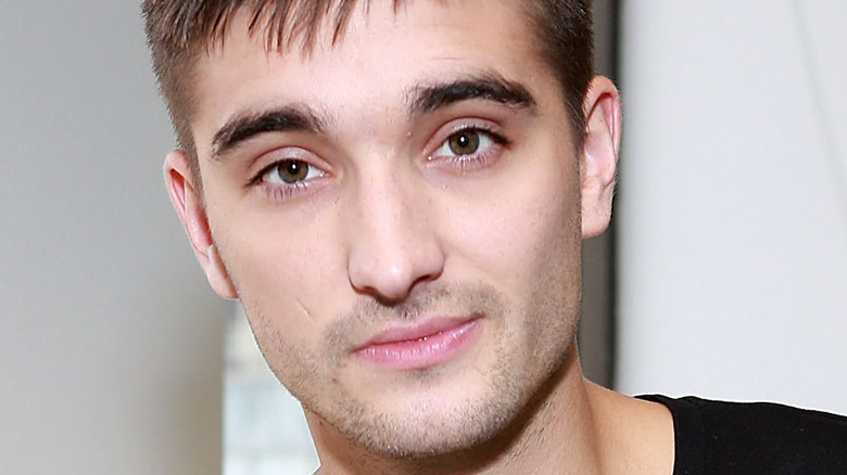 tom parker of the wanted grinning 