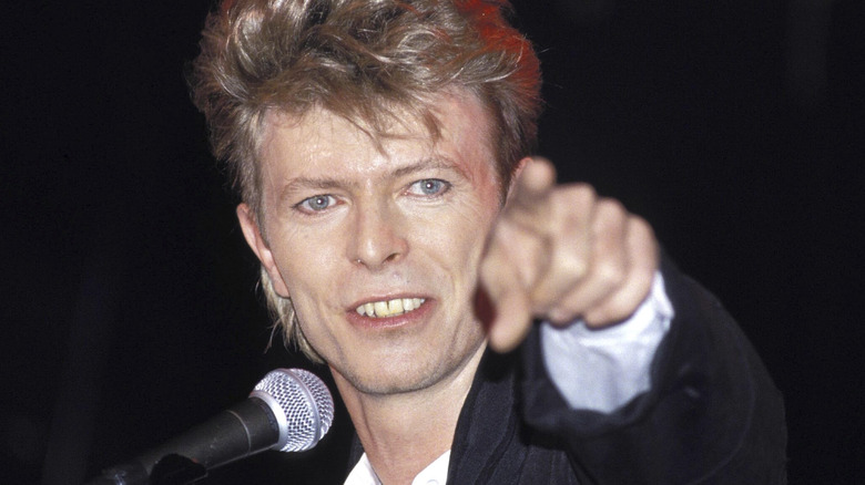 David Bowie pointing from stage
