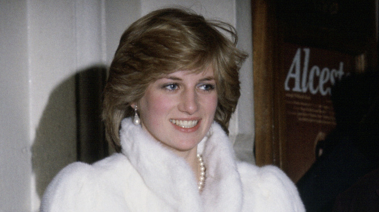 Princess Diana attends the Opera House wearing a white coat