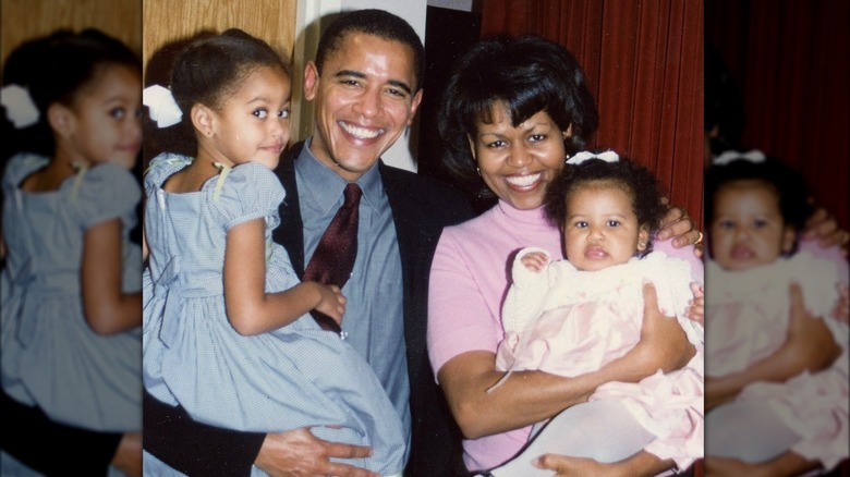Barack and Michelle Obama smiling with daughters Malia and Sasha Obama