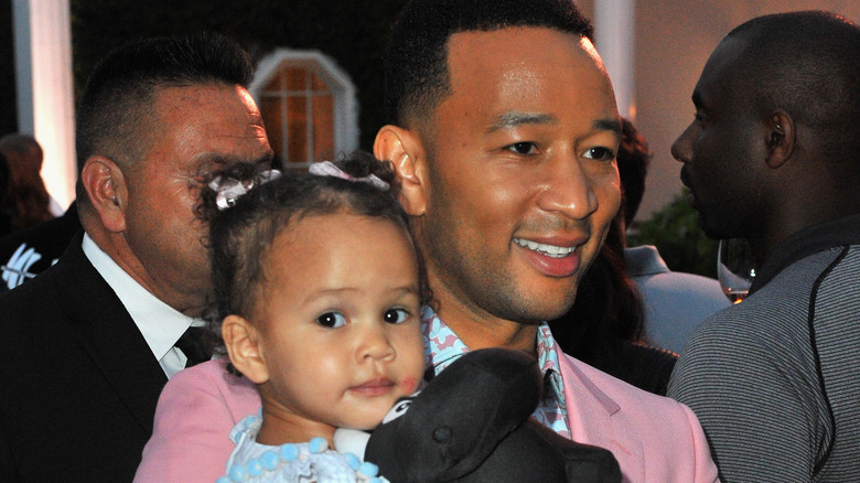 John Legend carrying his daughter Luna