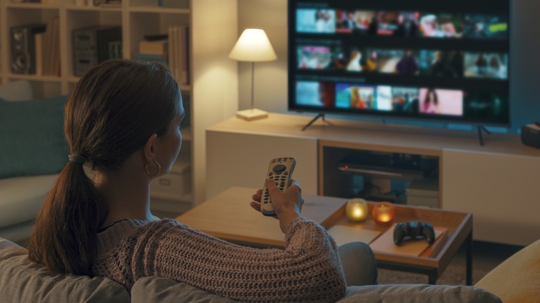 Woman watching TV on couch