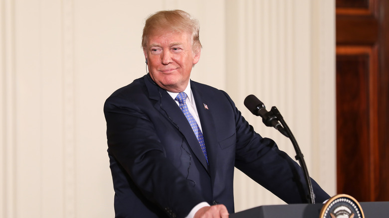 Donald Trump standing at a podium outside the White Hosue