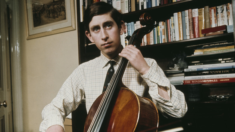 A young King Charles III playing a cello