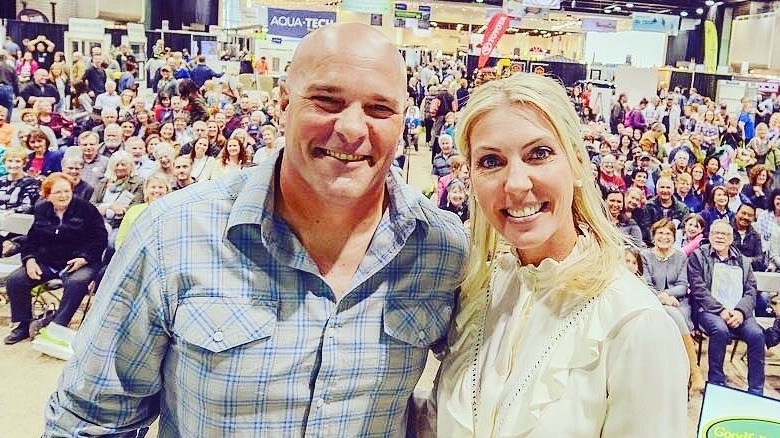 Bryan And Sarah Baeumler pose onstage together